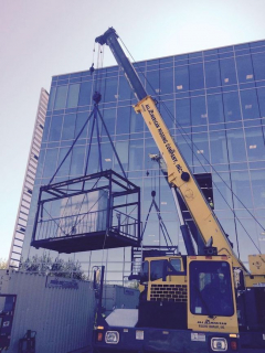 <p>Hoisting air handler unit into window opening of office building in Houston.</p>